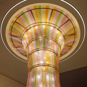 Custom colored glass chandelier with warm LED light for a hotel lobby